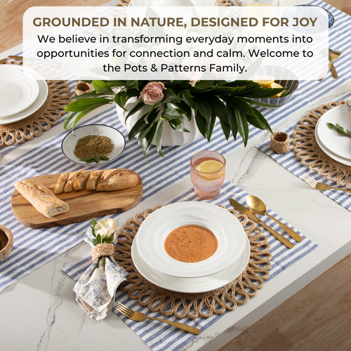 Table setting with plates, bread, and flowers on a striped tablecloth, with text about transforming moments for connection and calm.